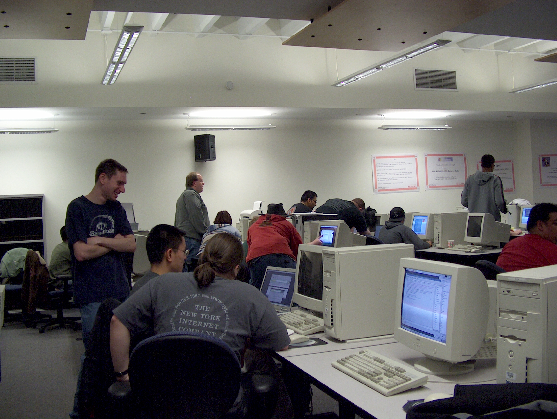 A group of diverse people using computers with the Linux operating system.